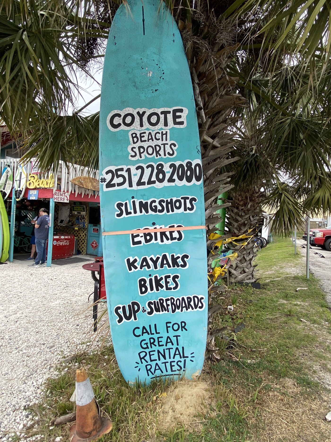 Coyote Beach Sports surfboard sign